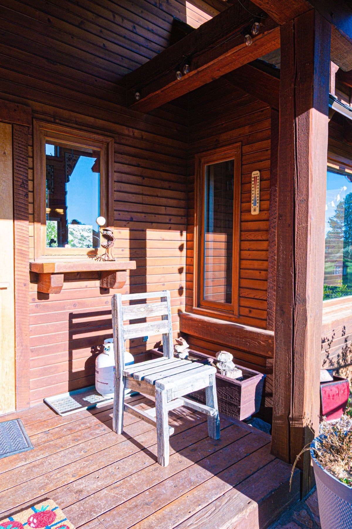 Rustic wood porch detail with chair and architectural beams