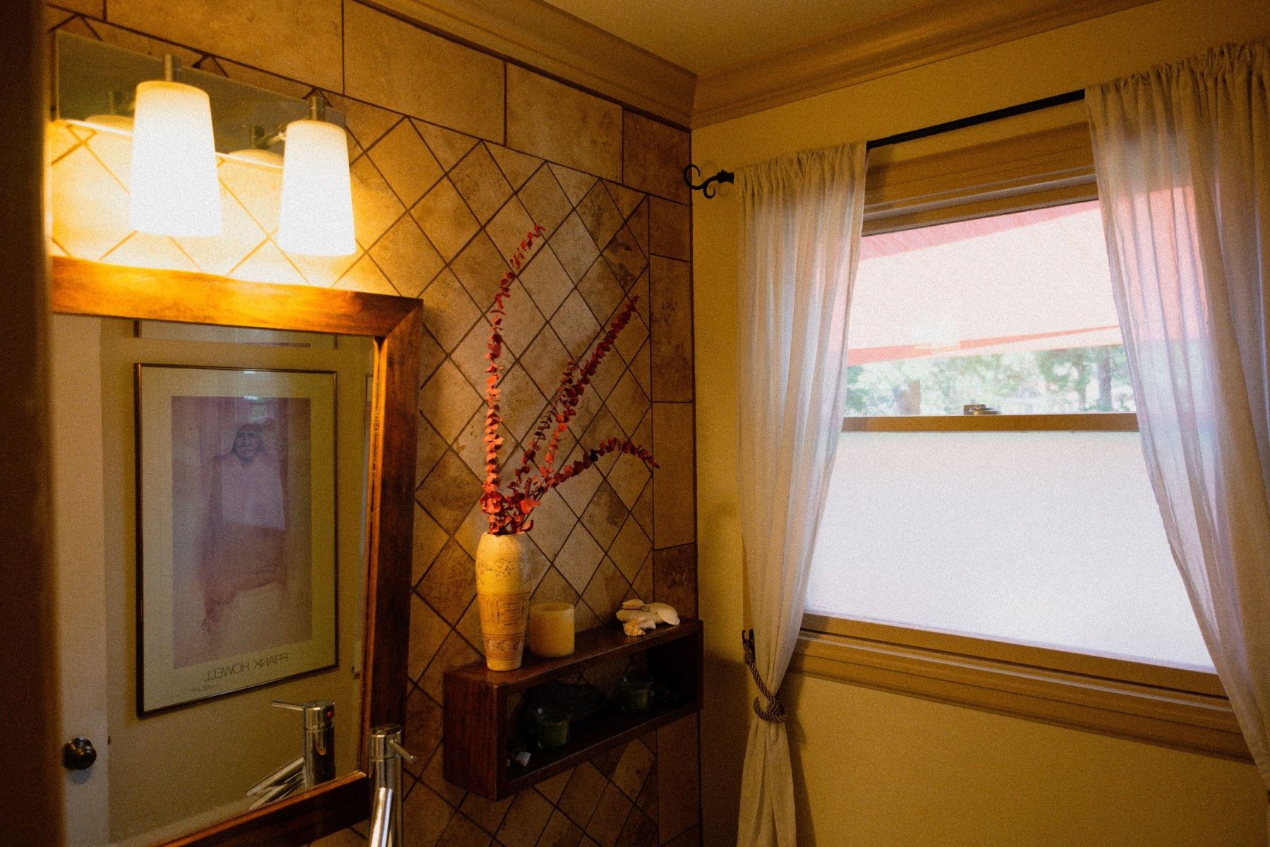 Bathroom vanity and window with warm natural finishes